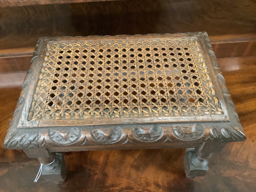 An early 20th century carved oak stool, width 29cm